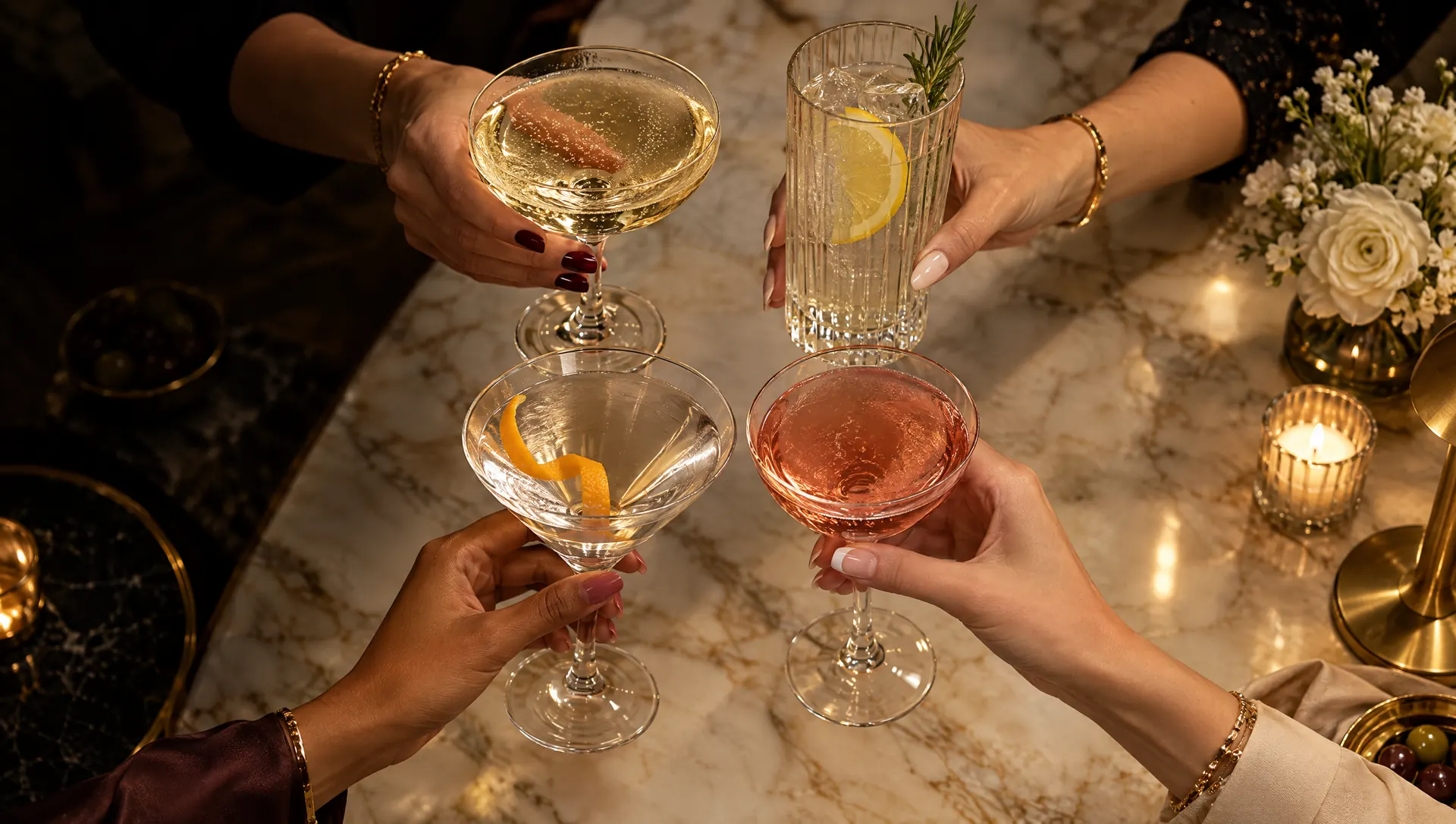 Four glasses raised over marble
